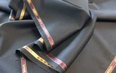 Elegancka, czarna wełna z metką "Super 120's Virgin Wool". Idealna na garnitur.